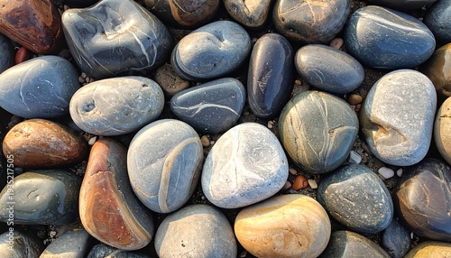 Close-up of various wet, smoothed, colorful, rounded rocks