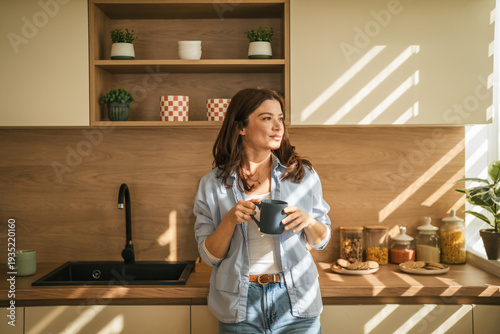 Canvas Print Woman enjoying morning coffee in sunlit kitchen thinking
