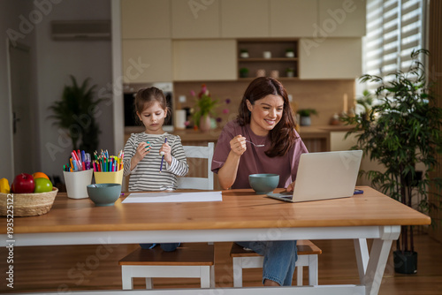 Mother and daughter balancing remote work and family life