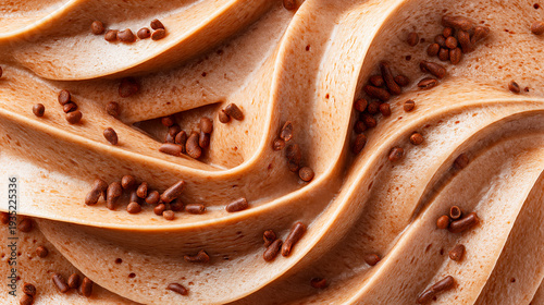 Extreme close up of smooth chocolate cream texture with glossy swirls and scattered sprinkles