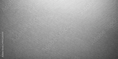 Abstract a textured silver metal background, subtly illuminated with a soft light source. The surface presents a sense of industrial elegance.