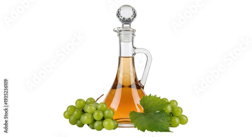 Isolated cruet of golden liquid near fresh grapes on a table, elegant bottle, clear glass