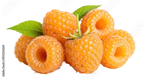 Isolated pile of vibrant golden raspberries with green leaves, fresh fruit concept