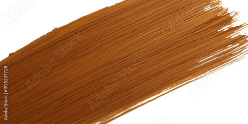 A paintbrush with wet paint glides across a textured brown wooden plank surface to create a natural grain pattern on the timber board