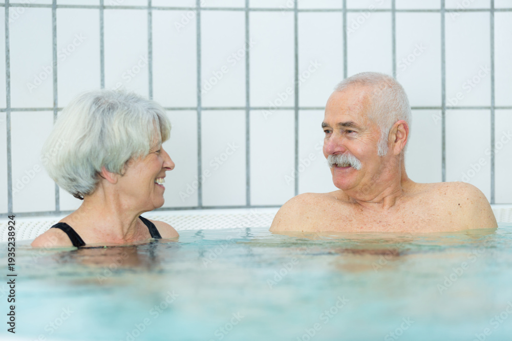 Fototapeta premium couple of seniors enjoys the pool and retirement
