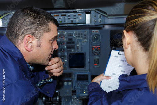 Φωτογραφία male and female engineers in aircraft cockpit