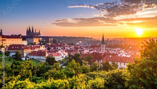 European city panorama at sunset. Red-roofed buildings cluster under a hill topped with a grand castle, lit by golden sun
