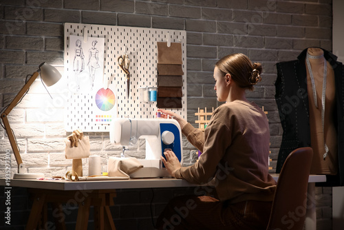 Female tailor using sewing ...