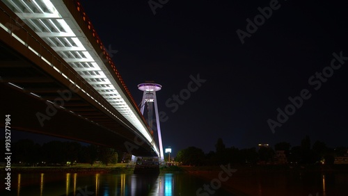 Photography Night view of the SNP Bridge with the UFO observation deck over the Danube river