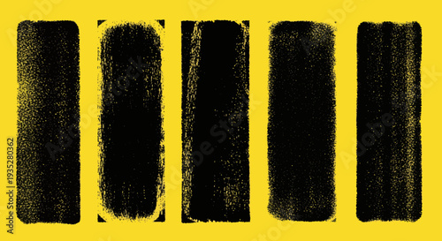 Five black brush strokes on yellow surface viewed from directly above in a graphic design context