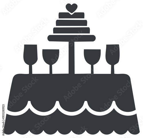 Elegant tiered wedding cake with heart and celebratory glasses on a party table