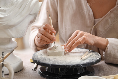 Female sculptor making figu...