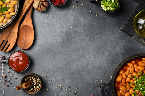 Dishes made from boiled beans. Culinary food background on a gray stone background. Top view.