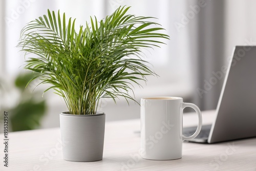 A close-up of a lush areca palm in a gray pot, a white mug, and a laptop on a desk, creating a serene and productive workspace in a modern office.