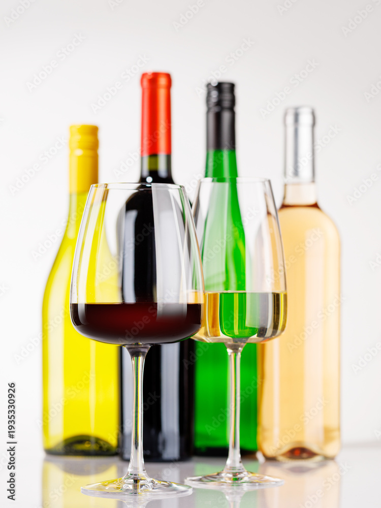Fototapeta premium Different wine bottles and glasses on white background