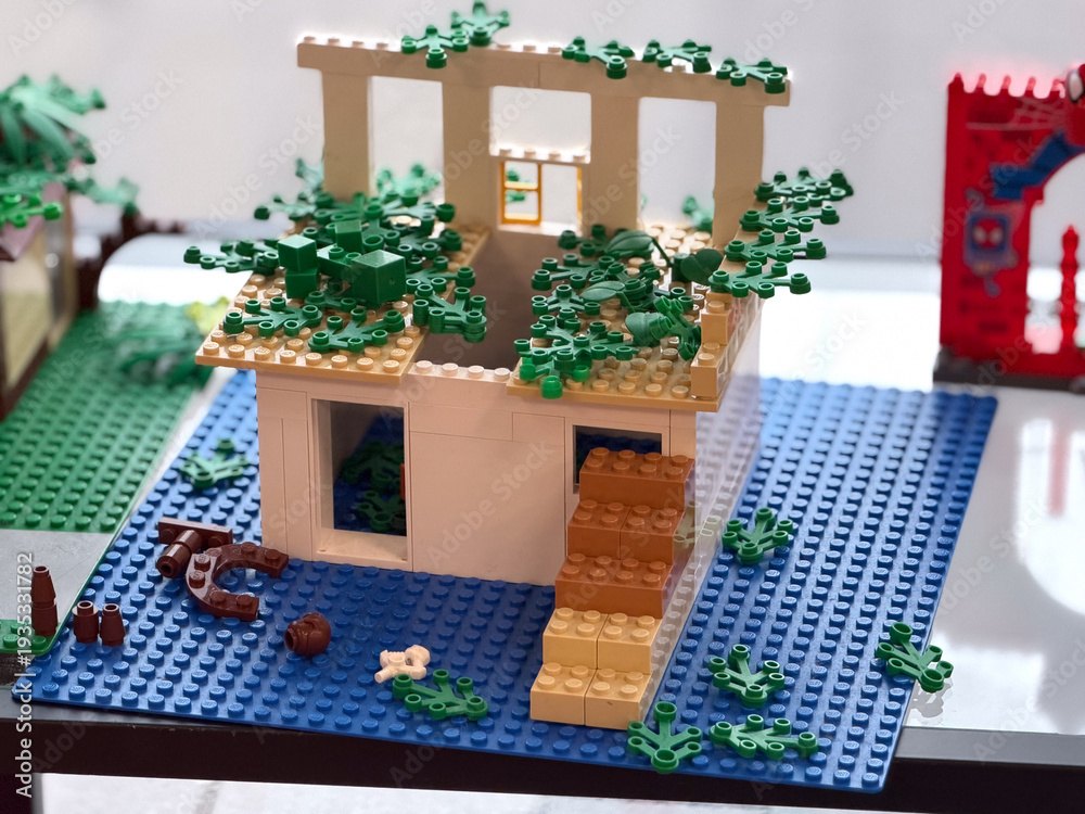 Obraz premium Overgrown lego two-story house with roof foliage
