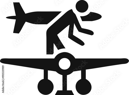 Maintenance worker inspects the wing of a large airplane with another aircraft flying overhead