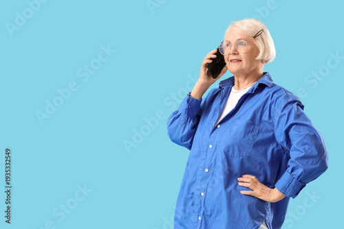 Senior woman talking by mob...