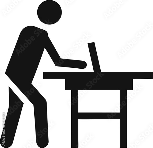 Modern professional diligently working on a laptop computer at an ergonomic standing desk