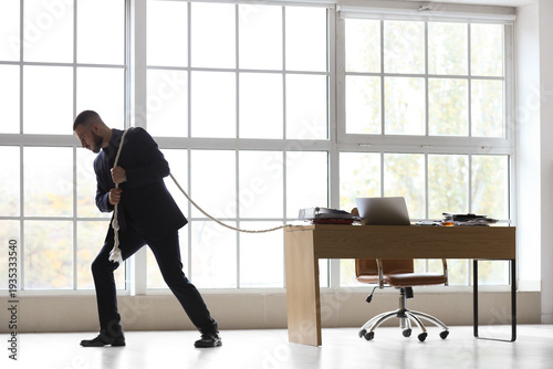 Businessman pulling rope wi...