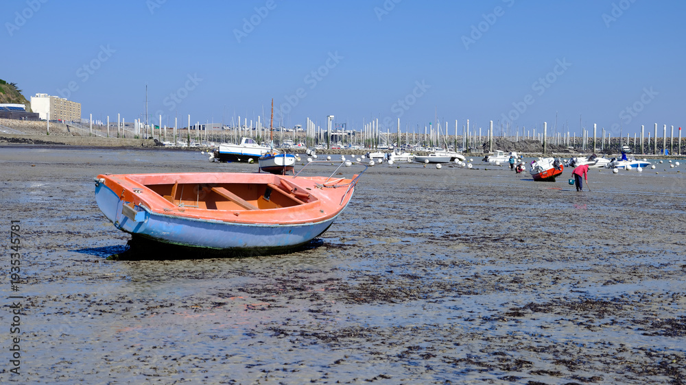 Fototapeta premium Port and beach at low tide at Saint-Cast-le-Guildo, a commune in the Côtes-d'Armor department of Brittany in northwestern France