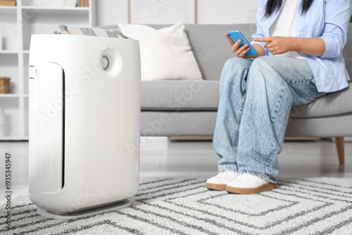 Air purifier near young wom...