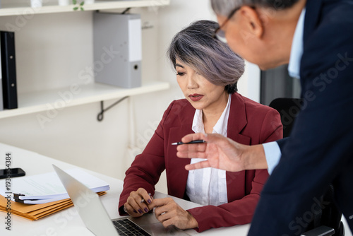 Lawyer team diligently reviewing legal documents at desk.Law and Legal services concept.