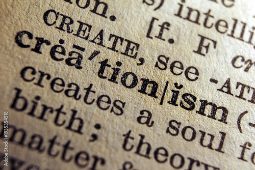 Tableau sur toile Word creationism printed on dictionary page, macro close up