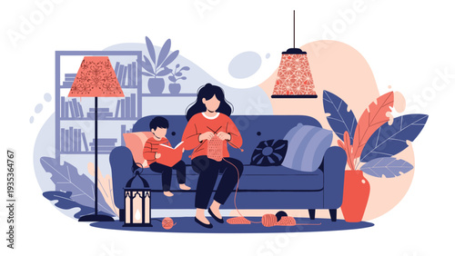 Mother sitting on a sofa and knitting with pink yarn while her young son reads a book next to her in a cozy home living room.