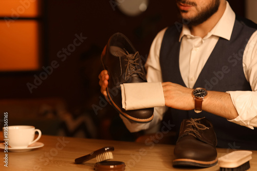 Man wiping shoe in room at ...
