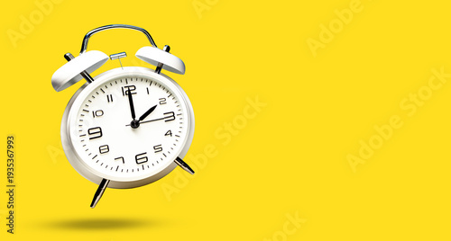 Wallpaper Mural White bell alarm clock hovering over yellow background. 2 to 3 clock concept isolated. time change Torontodigital.ca