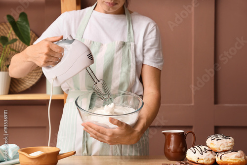 Woman whipping egg whites w...