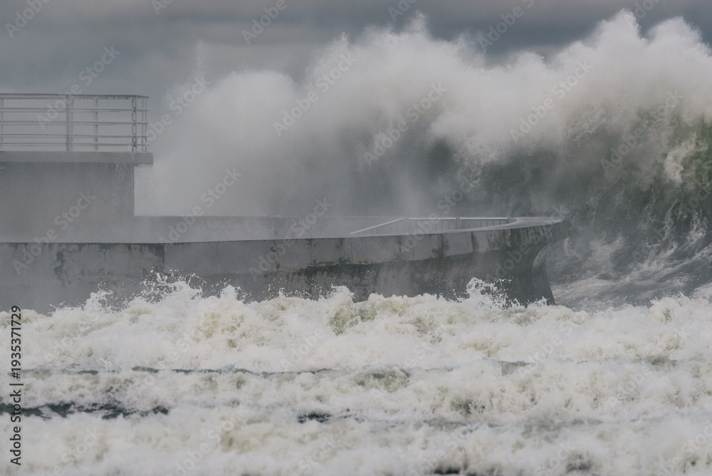 Fototapeta premium STORM AT SEA - Powerful waves of foaming sea water at the pier