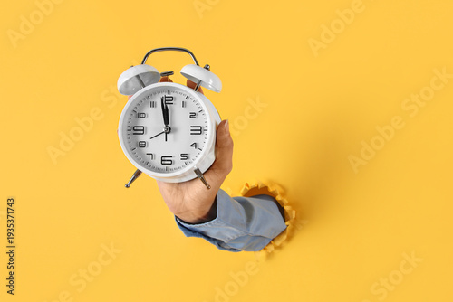 Female hand with alarm cloc...