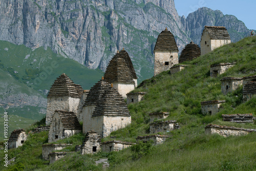 Ancient crypts of the City of the Dead in the mountains of Ossetia on a sunny June day. North Ossetia-Alania, Russian Federation