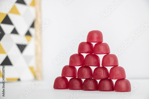 Tableau sur toile A pyramid of gummy candy, with an abstract pattern in the background