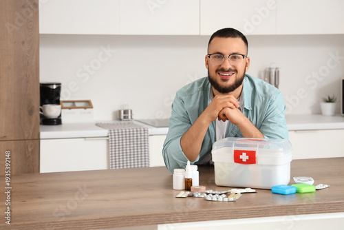 Young man with first aid ki...