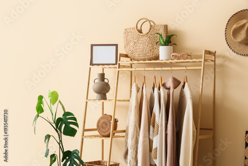 Wooden rack with stylish cl...