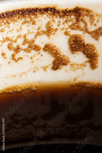 Coffee cup side macro of foam bubbles residue