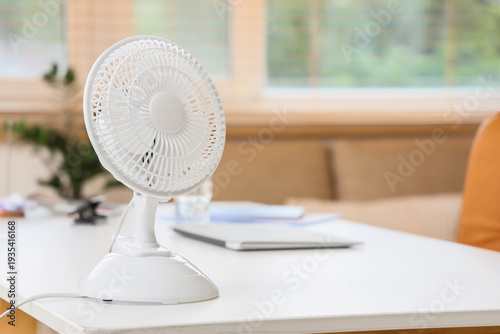 фотографія Electric fan on desk in office, closeup