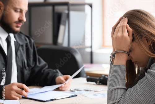 Upset woman with handcuffs ...