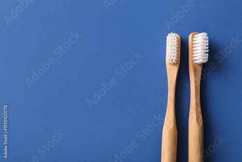 Bamboo toothbrushes on blue background