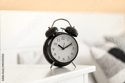Black alarm clock on table ...
