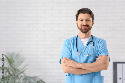 Portrait of handsome smiling doctor in clinic