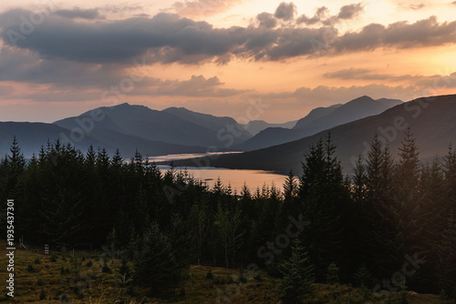 Sunset View Over Pine Forest and Mountain Valley with Lake