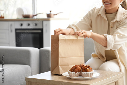 Young woman with paper bag ...