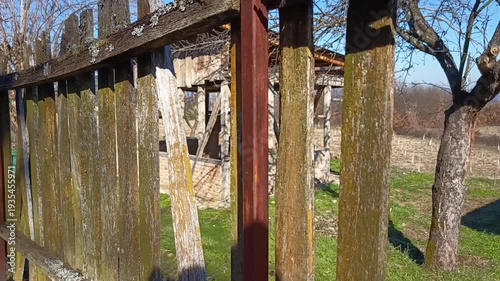 Weathered wooden fence with moss in rural countryside landscape