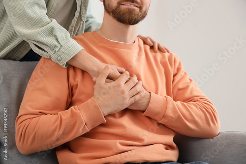 Young man holding his wife'...