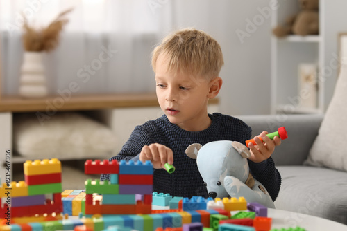 Happy cute little boy playi...