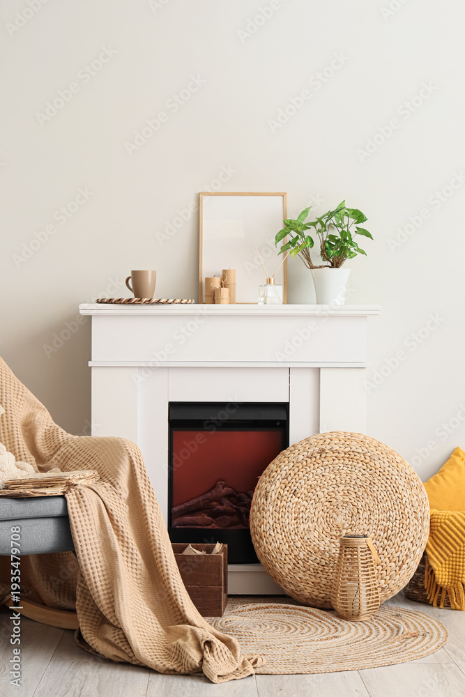 Fototapeta premium Old book on armchair near fireplace in living room